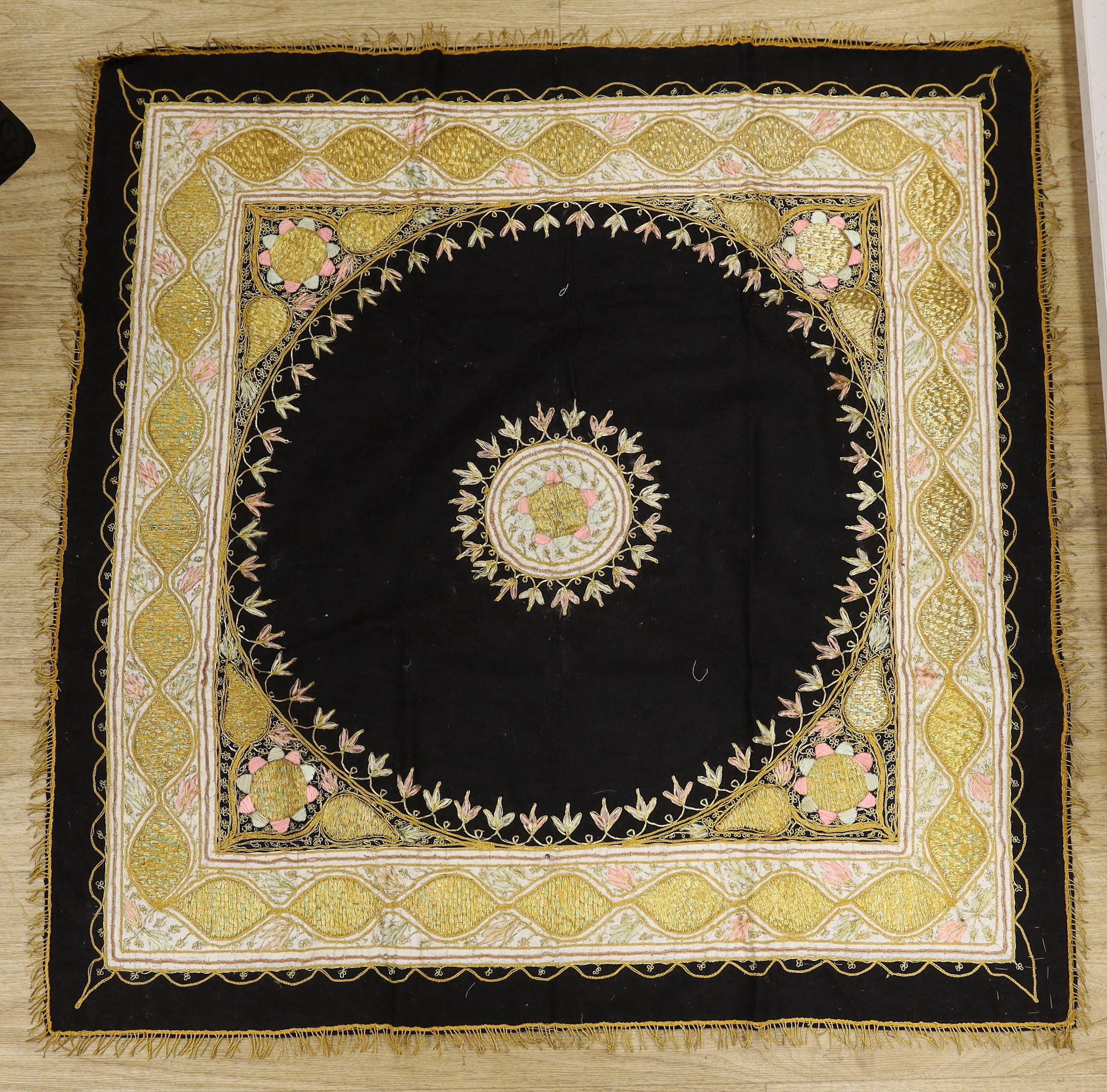 An embroidered Indian felt cover, a cream satin pageboy outfit, a white work christening gown, a silk shawl, a knitted silk shawl and a length of brocade